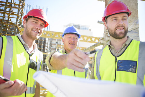 Three construction workers in construction site - ZEF001601