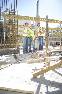 Three construction workers in construction site - ZEF001951