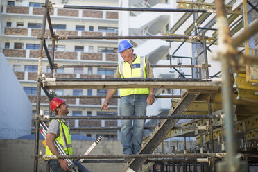 Surveyor and construction worker on construction site - ZEF001612