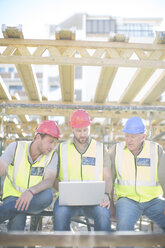 Construction workers with laptop having a break - ZEF001627