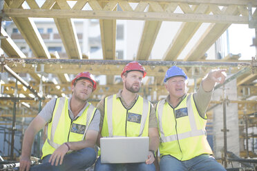 Construction workers with laptop having a break - ZEF001628