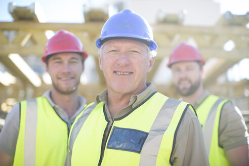 Portrait of confident construction workers in construction site - ZEF001636