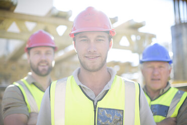 Portrait of confident construction workers in construction site - ZEF001637