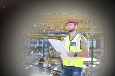 Construction worker holding plan at construction site - ZEF001638