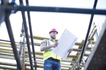 Construction worker reading plan at construction site - ZEF001656