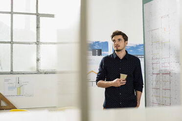 Young architect in office thinking - UUF002782