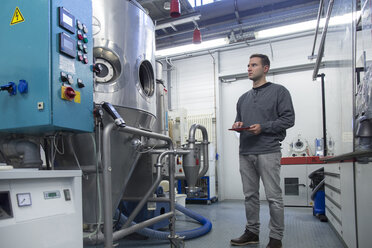 Young man with digital tablet in technical room - SGF001201