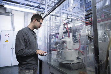 Young man with digital tablet in technical room - SGF001202