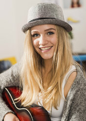 Portrait of smiling blond female teenager wearing hat - UUF002768