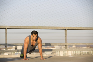 Muscular man doing pushups - MAD000129