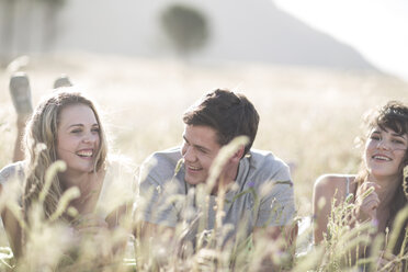 South Africa, Friends lying in field, having fun - ZEF002607