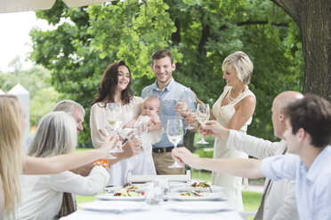 Baby being introduced to family on a garden party - ZEF003476