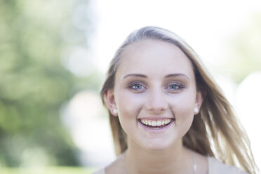 Portrait of smiling blond young woman outdoors - ZEF003498