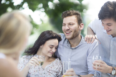 Happy friends drinking wine outdoors - ZEF003502