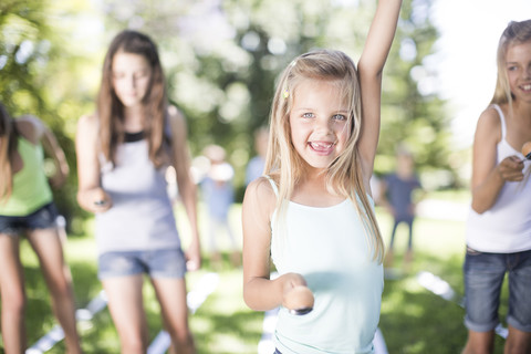 Girl winning in an egg-and-spoon race stock photo