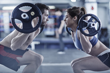 Man and woman doing fitness training with weights - ZEF002629