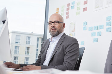 Portrait of businessman working in office - RBF002127