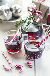 Glasses of mulled wine, candy canes and Christmas decoration - SBDF002166