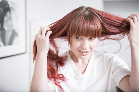 Porträt einer Frau, die ihr Haar hält, lizenzfreies Stockfoto