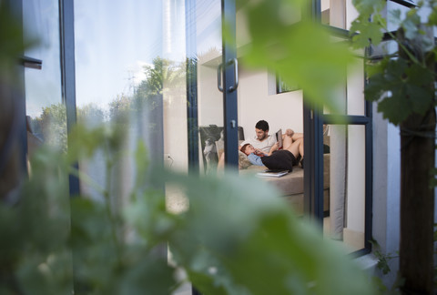 Couple relaxing together on a couch stock photo