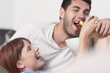 Young couple sharing a fruit salad - ZEF002973