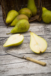 Wickerbasket, pears and pocket knife on grey wood - LVF002466