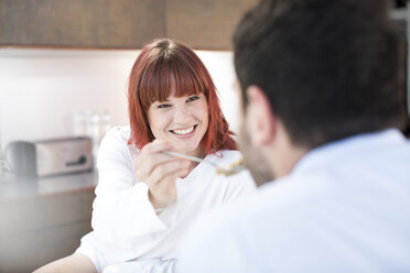 Couple eating in kitchen - ZEF002643