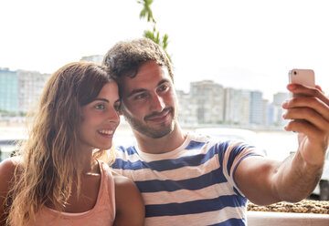 Young couple taking a selfie with smartphone - MGOF000002