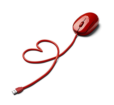 Red computer mouse and cable shaped like a heart on white ground stock photo