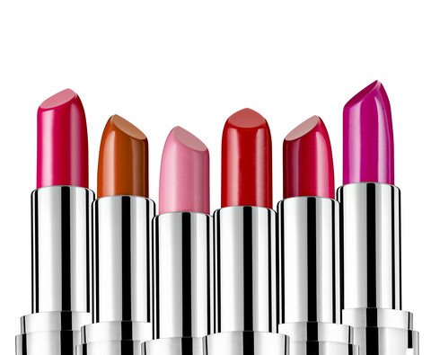 Row of different lipsticks in front of white background stock photo