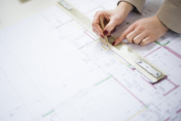 Close-up of architect working on construction plan - UUF002926