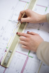 Close-up of architect working on construction plan - UUF002927