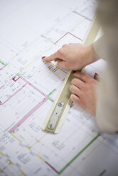 Close-up of architect working on construction plan - UUF002928