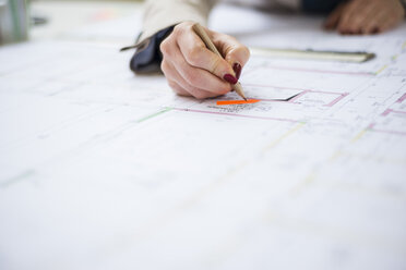 Close-up of architect working on construction plan - UUF002930