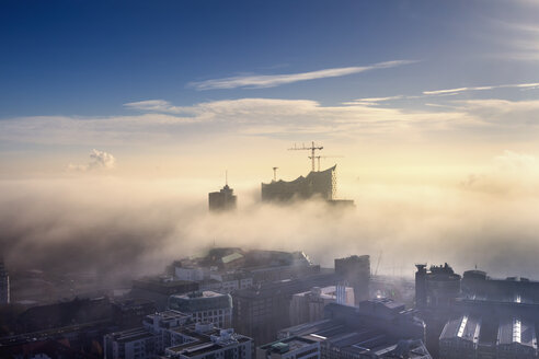 Germany, Hamburg, aerial view of the Elbphilharmonie and city in dense fog - NKF000220