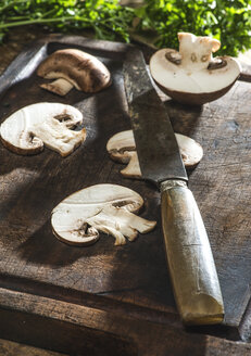 In Scheiben geschnittene Pilze und Messer auf Holzbrett - DEGF000083