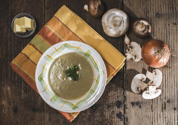 Mushroom soup and ingredients on vintage wooden table - DEGF000084