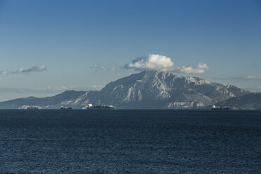 Spain, Andalusia, Tarifa, cargo ships passing Strait of Gibraltar in front of Mount Moses - KBF000257