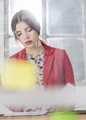 Young businesswoman with documents in office - UUF002983