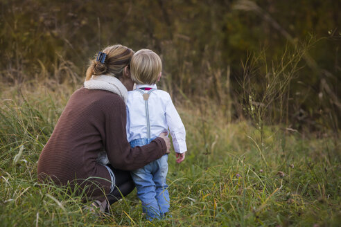 Mother with son on meadow - JTLF000012