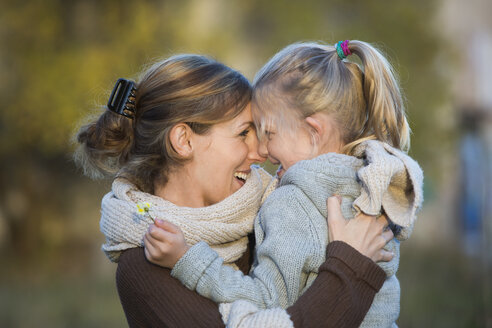 Laughing mother and daughter outdoors - JTLF000004