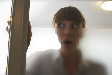 Frightened woman behind glass pane - STKF001136