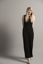 Portrait of blond young woman wearing black overall - UUF003030