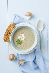 Creme of mushroom soup in light blue soup bowl, baguette slice - ECF001635