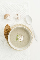 Creme of mushroom soup in white soup bowl, baguette slice - ECF001637