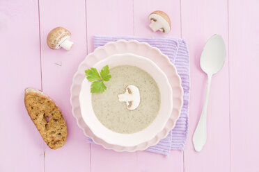 Creme of mushroom soup in pink soup bowl, baguette slice - ECF001638