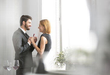 Elegant couple with engagement ring in restaurant - WESTF020393