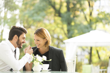 Smiling couple at outdoor cafe - WESTF020433