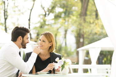 Smiling couple at outdoor cafe - WESTF020434