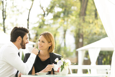 Smiling couple at outdoor cafe - WESTF020435